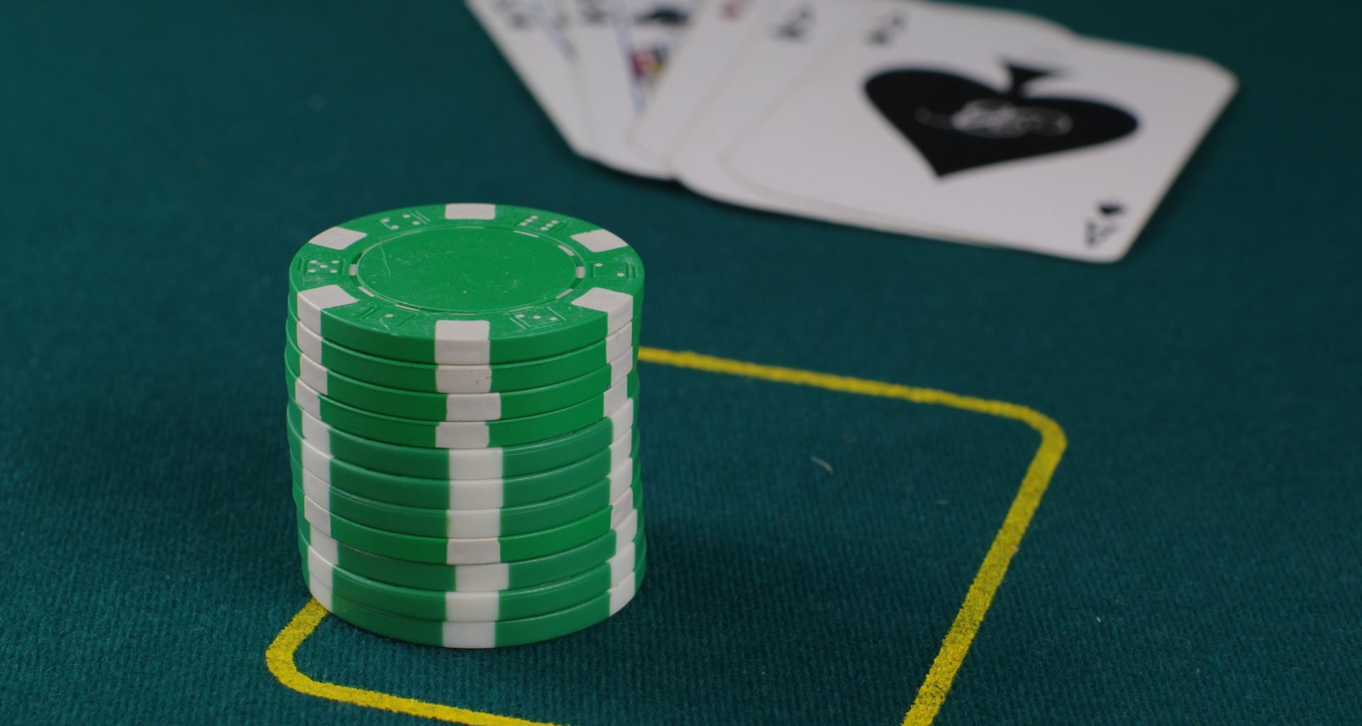 A stack of poker chips on top of a green table
