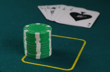 A stack of poker chips on top of a green table
